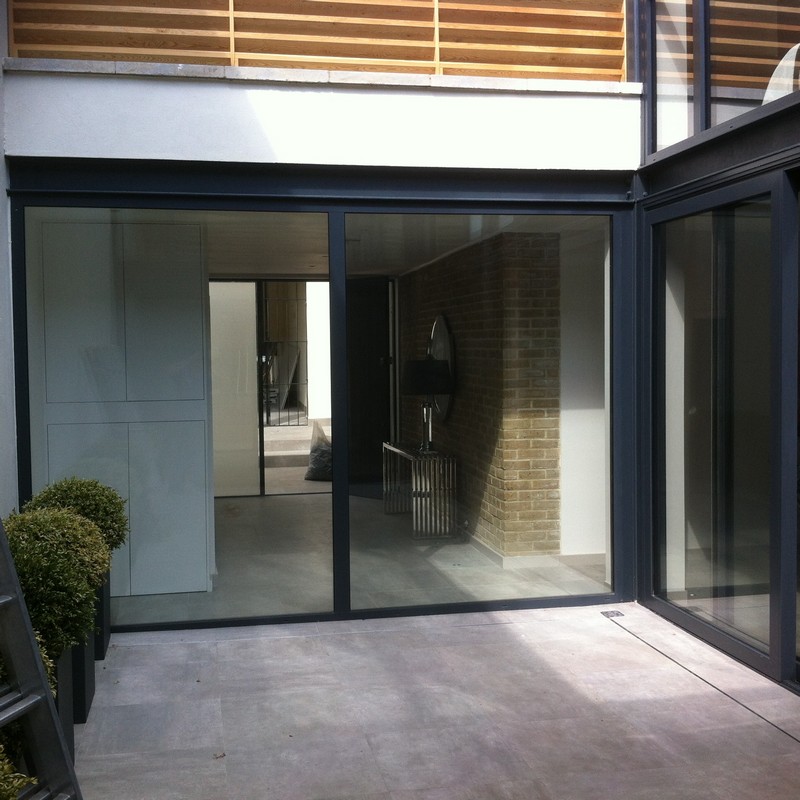 Floor-to-ceiling sliding doors opening to courtyard in Tring