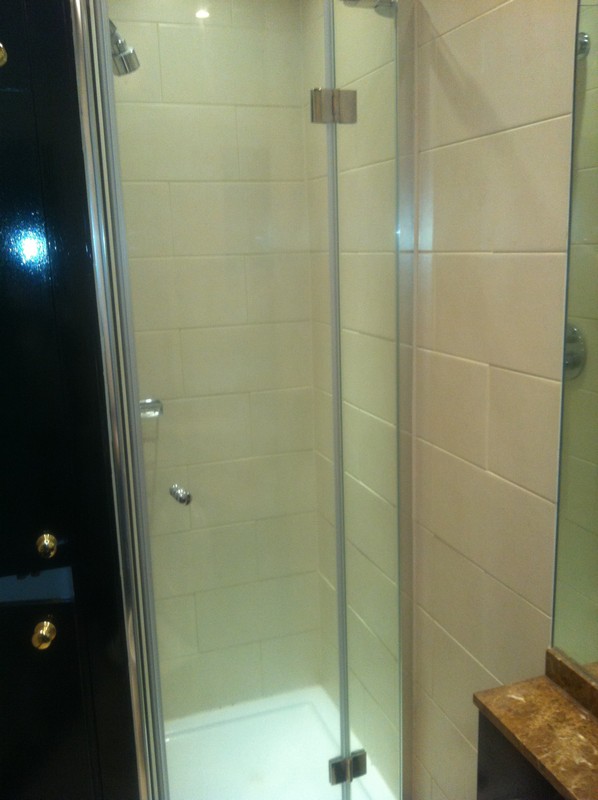 Frameless glass shower enclosure with chrome fittings in Tring