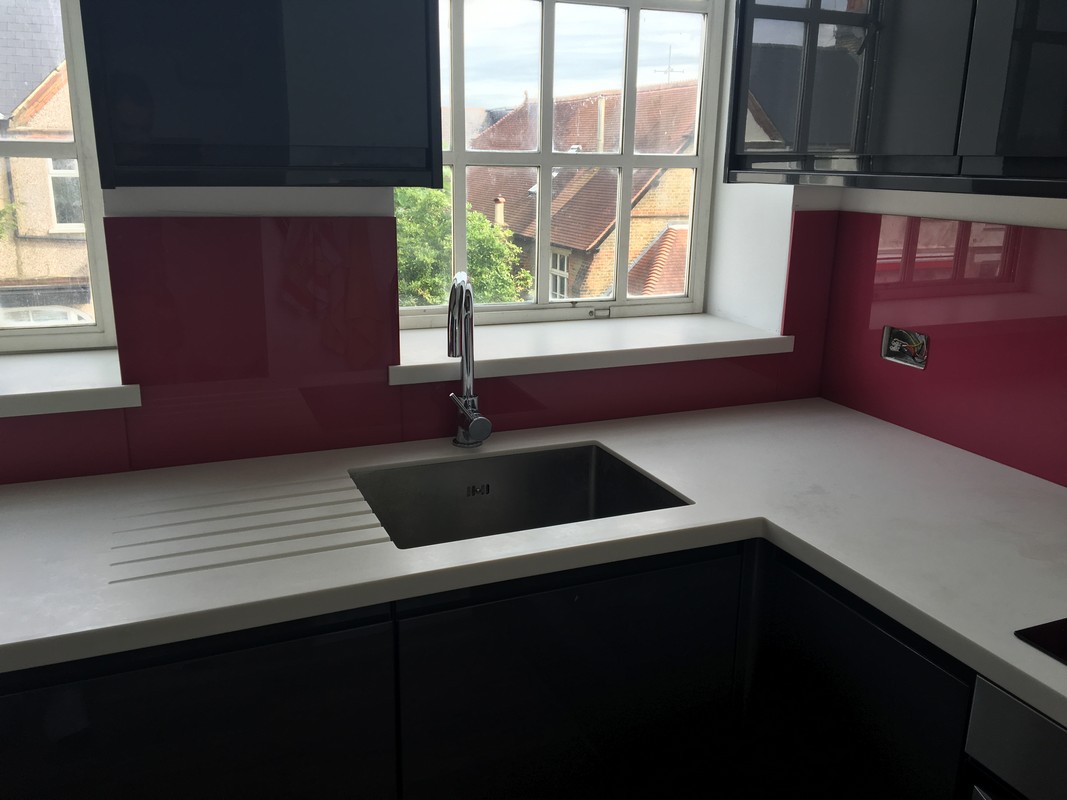 Deep plum coloured glass splashback in modern Tring kitchen